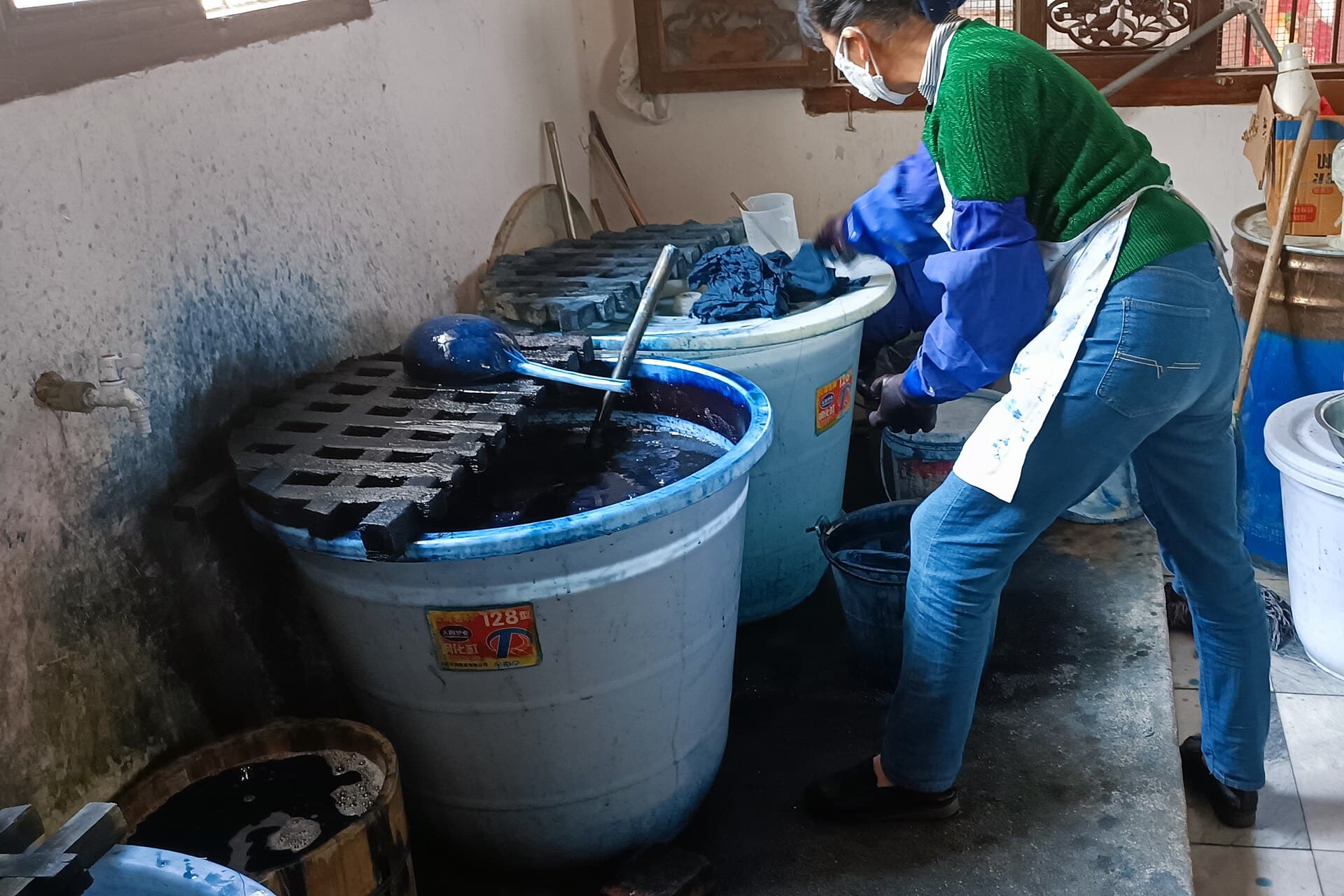 A Dali workshop dyeing cloth in deep blue indigo vats